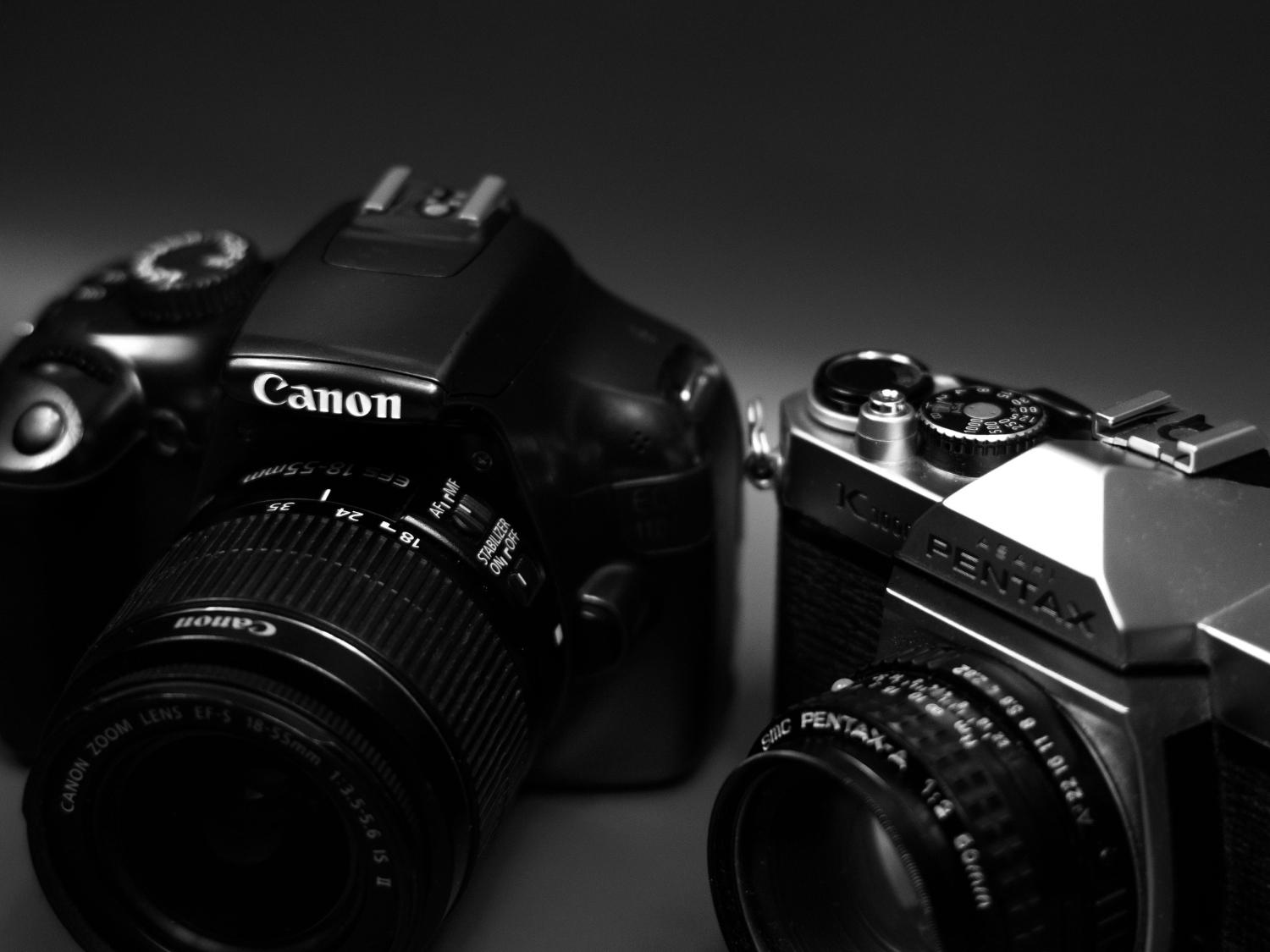 Canon DSLR and vintage Pentax film camera side by side, comparing analogue and digital photography.